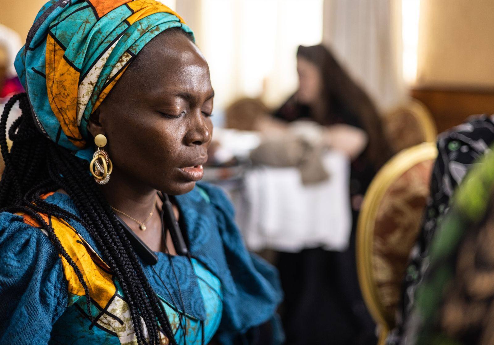 A participant concentrating during a Bible translation gathering in Entebbe